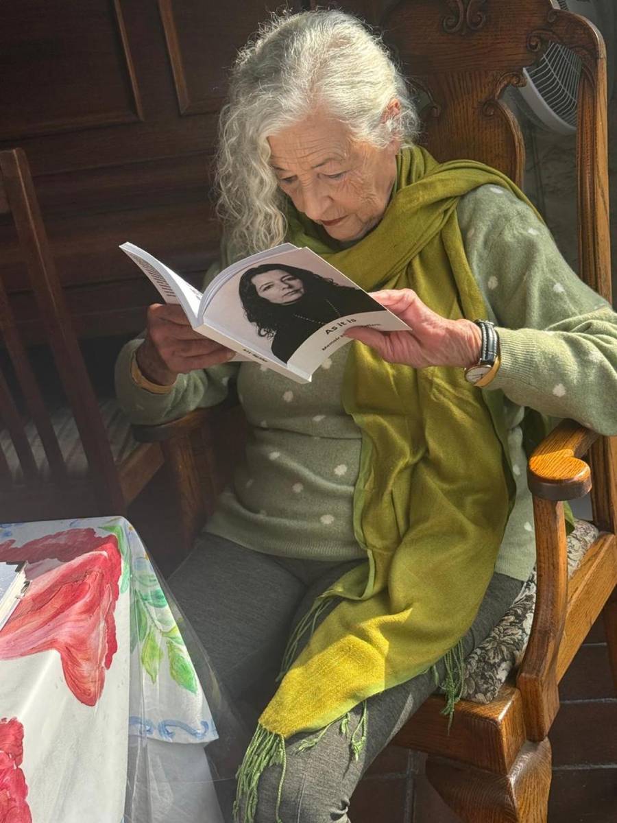 Maja reading her own printed Life Story book.